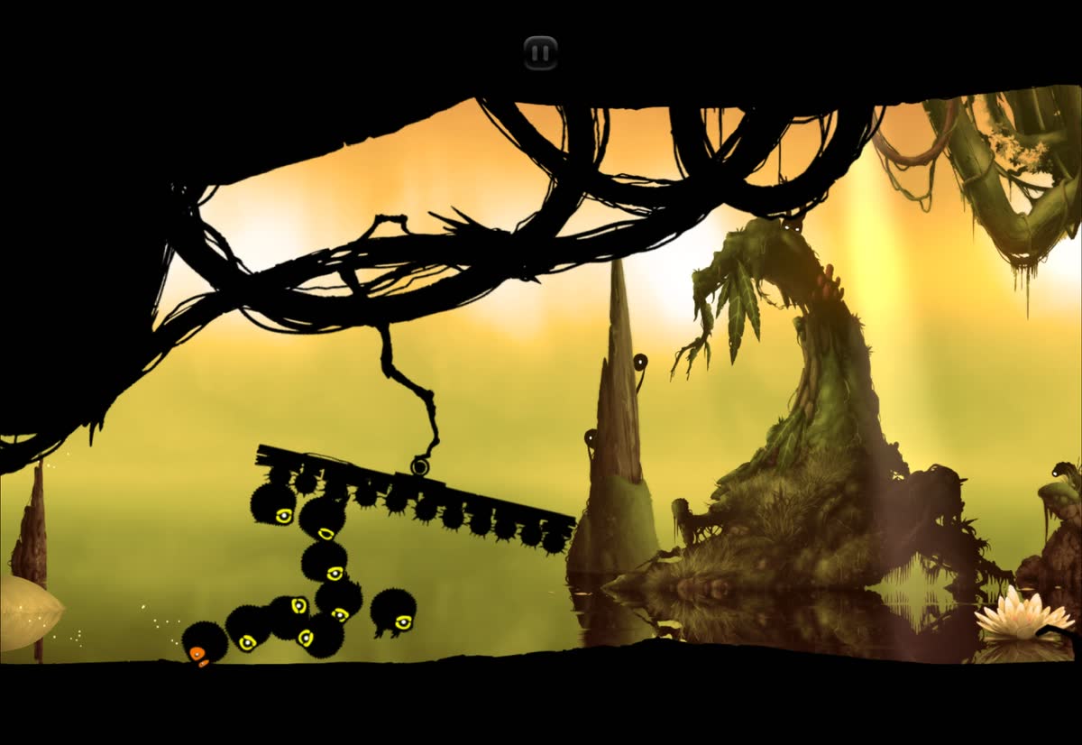 Badland co-op: a swarm of fluffy clones from two players crowds under a swinging spiked log in a golden forest
