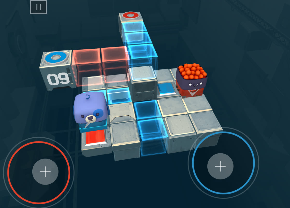 Death Squared level 09 on an iPad: the blue and the red robot cube have to reach their matching goal pads, with touch sticks for each player in the corners